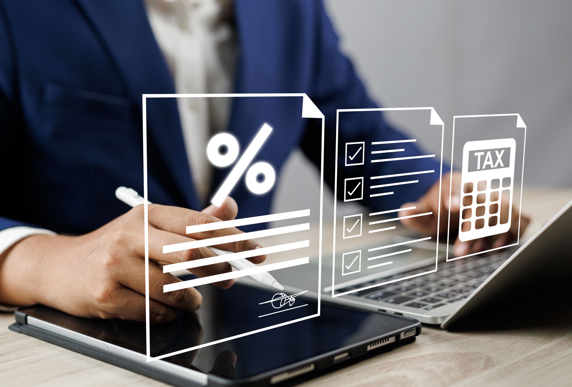 Tax and Vat concept. Government, state taxes concept. Businesman using tablet and laptop to complete Individual income tax return form online for tax payment. Data analysis, financial research.